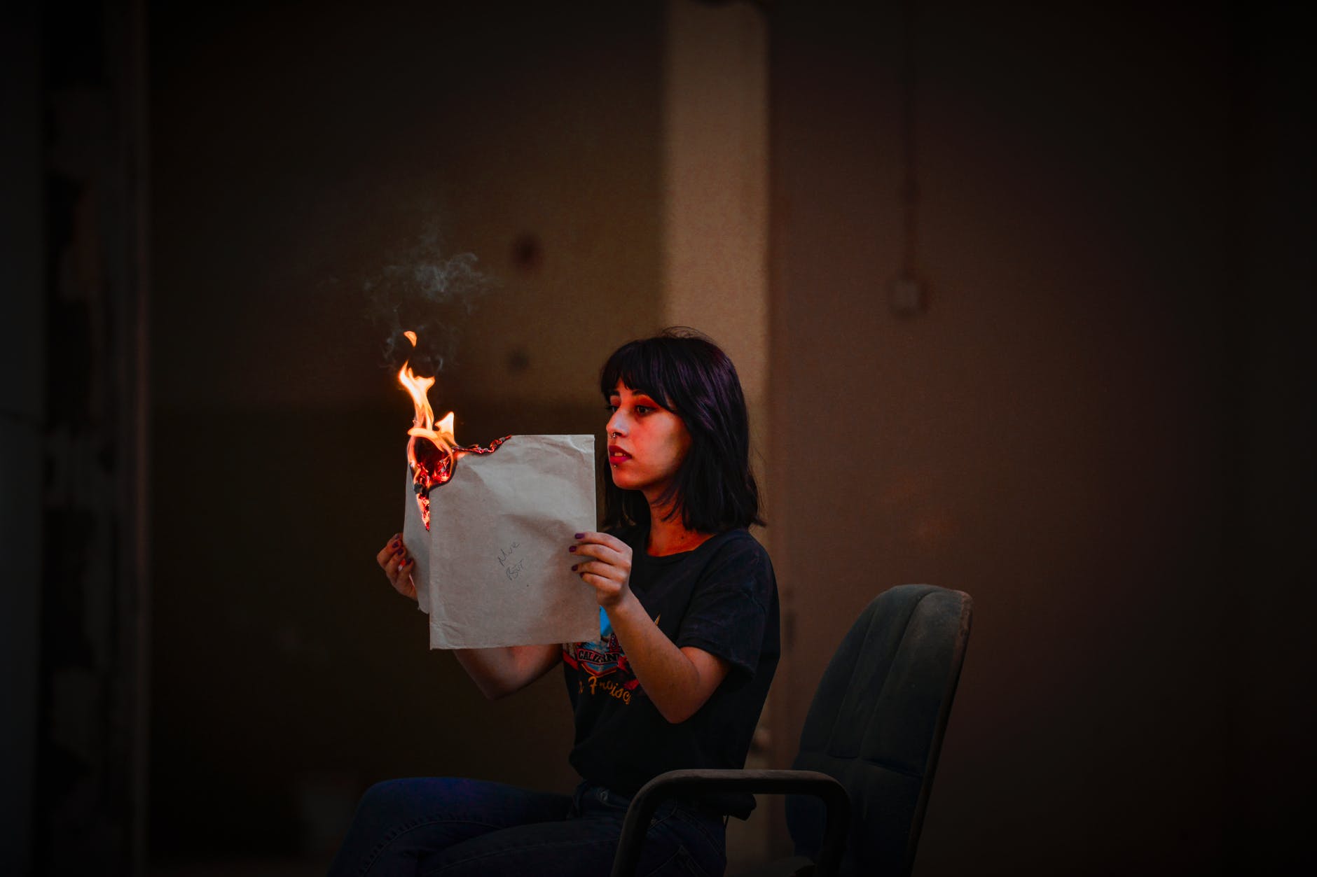 woman holding burning paper